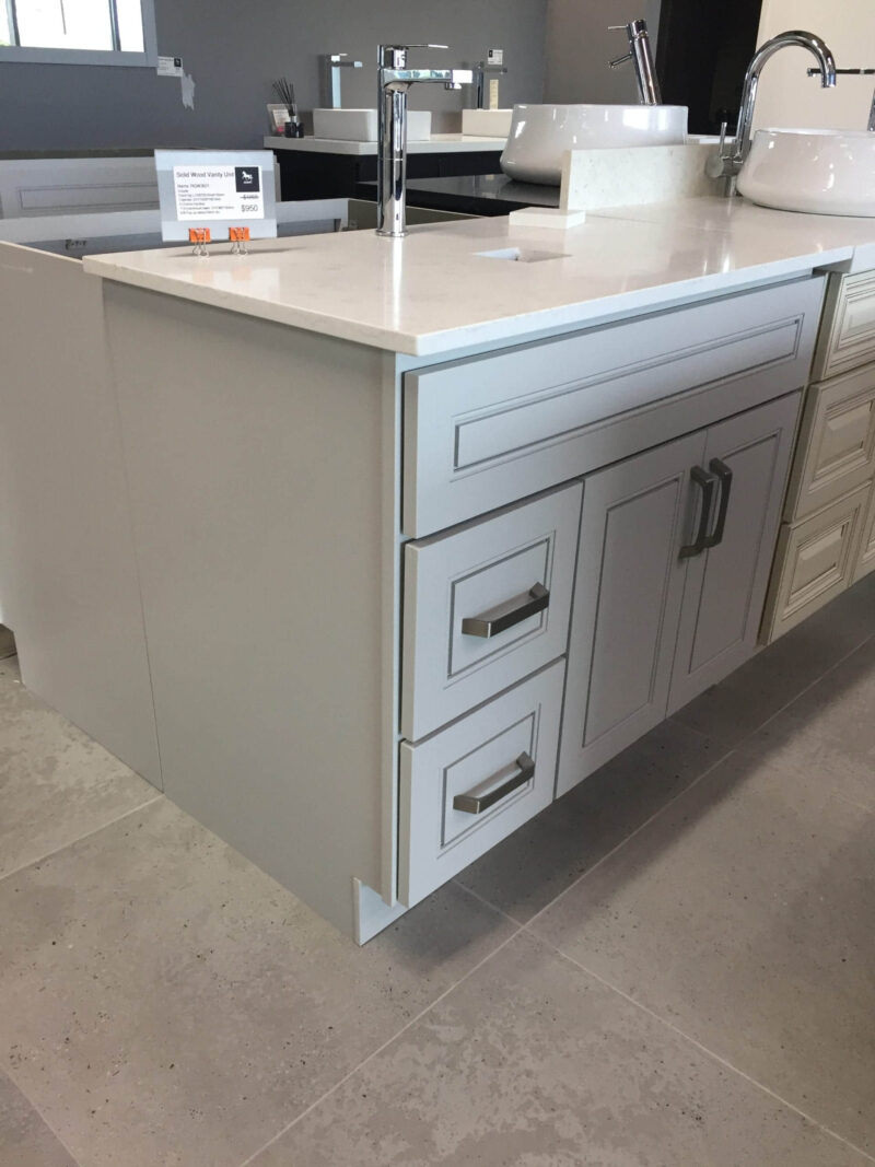 Modern kitchen island with white cabinets and sleek countertop.