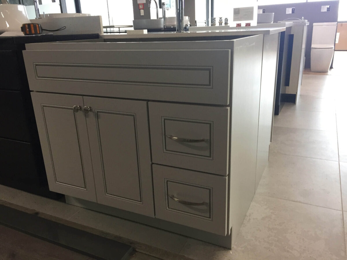 Modern kitchen island with drawers and cabinets in a showroom.
