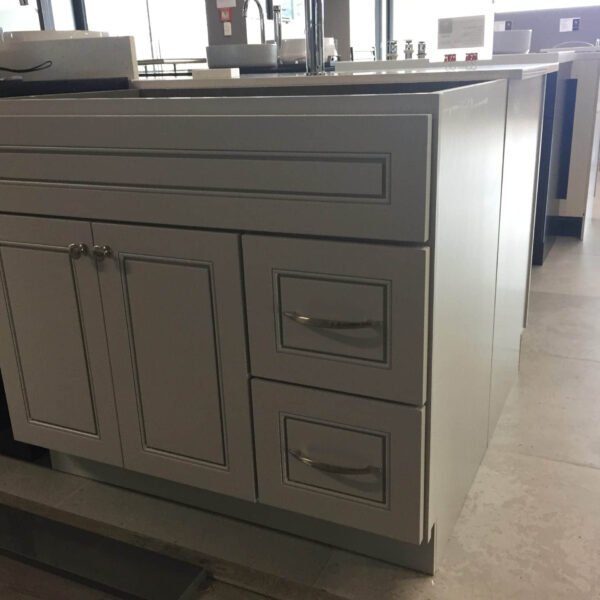 Modern kitchen island with drawers and cabinets in a showroom.