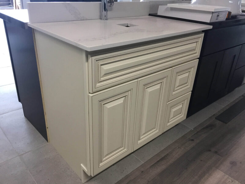 Matt black pop-up waste with overflow, 32mm, on carpeted surface.