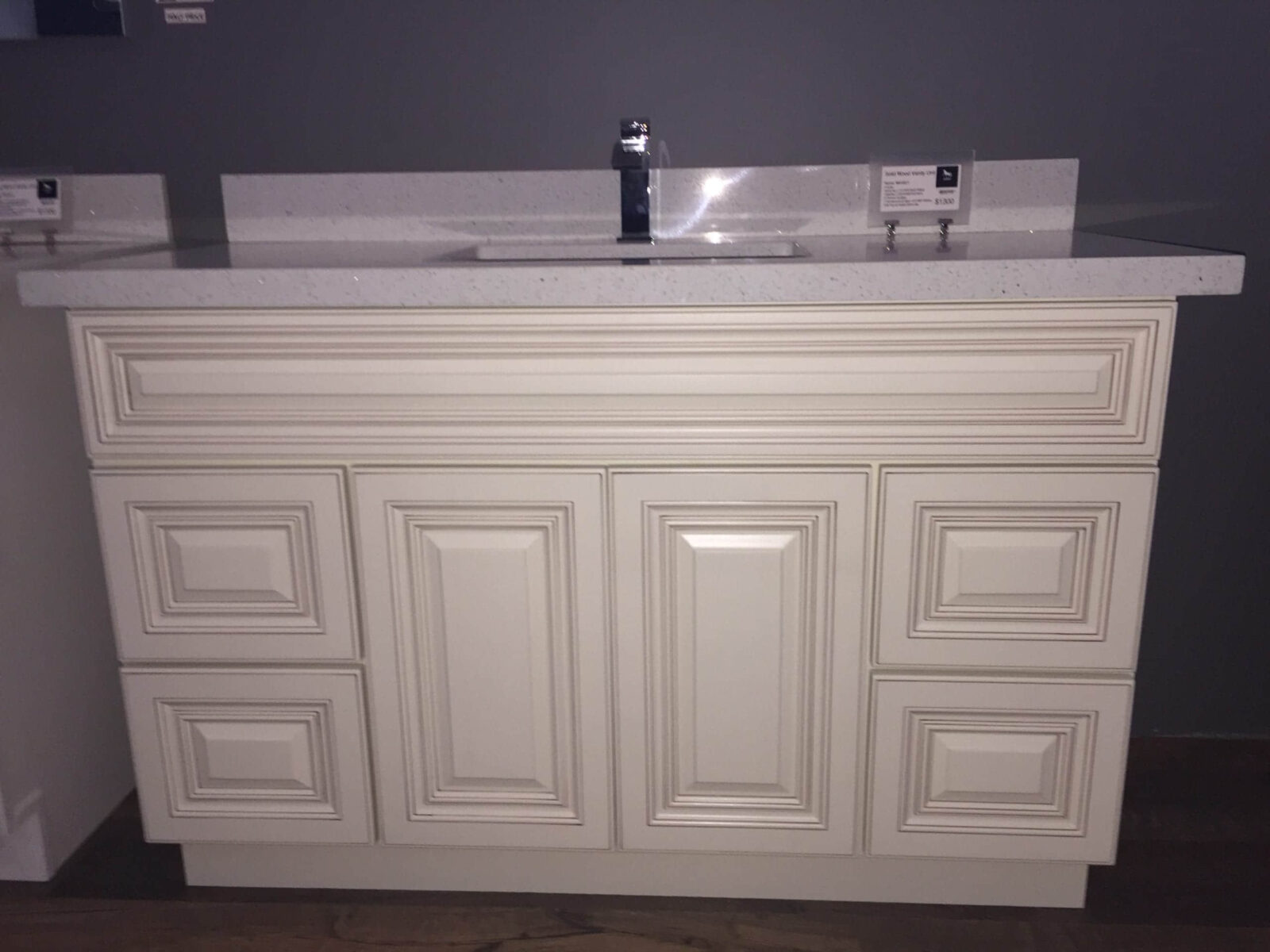 White kitchen cabinet with sink and faucet.