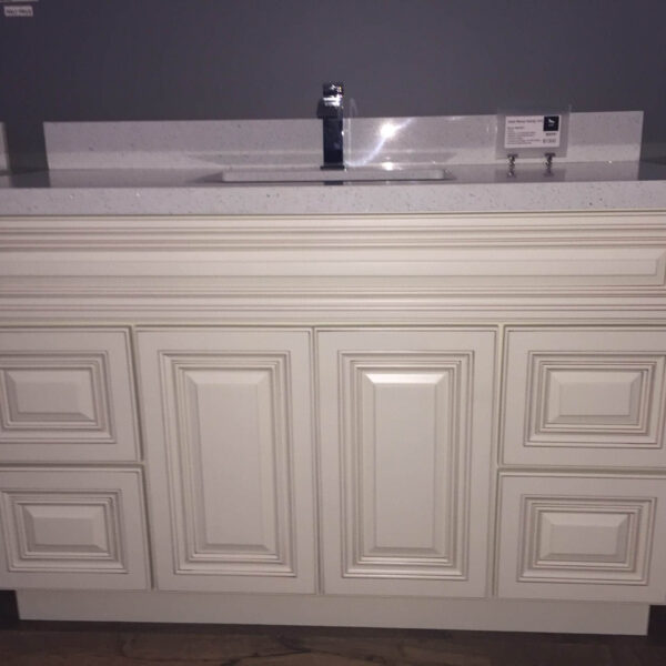 White kitchen cabinet with sink and faucet.
