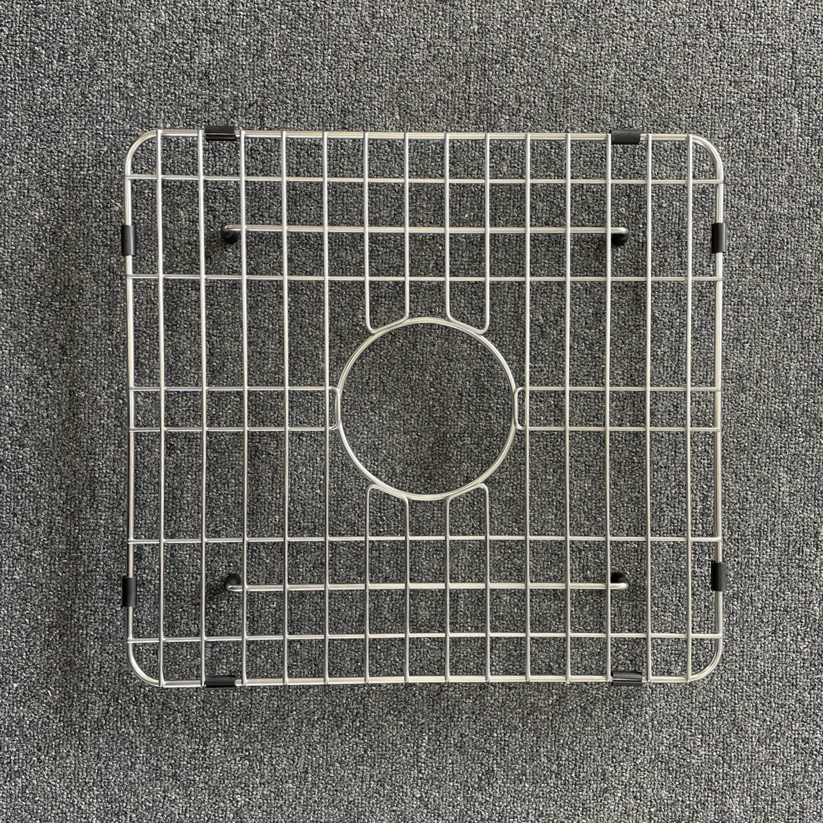 double-1-scaled-1.jpg Square metal sink grid on a gray carpet background.