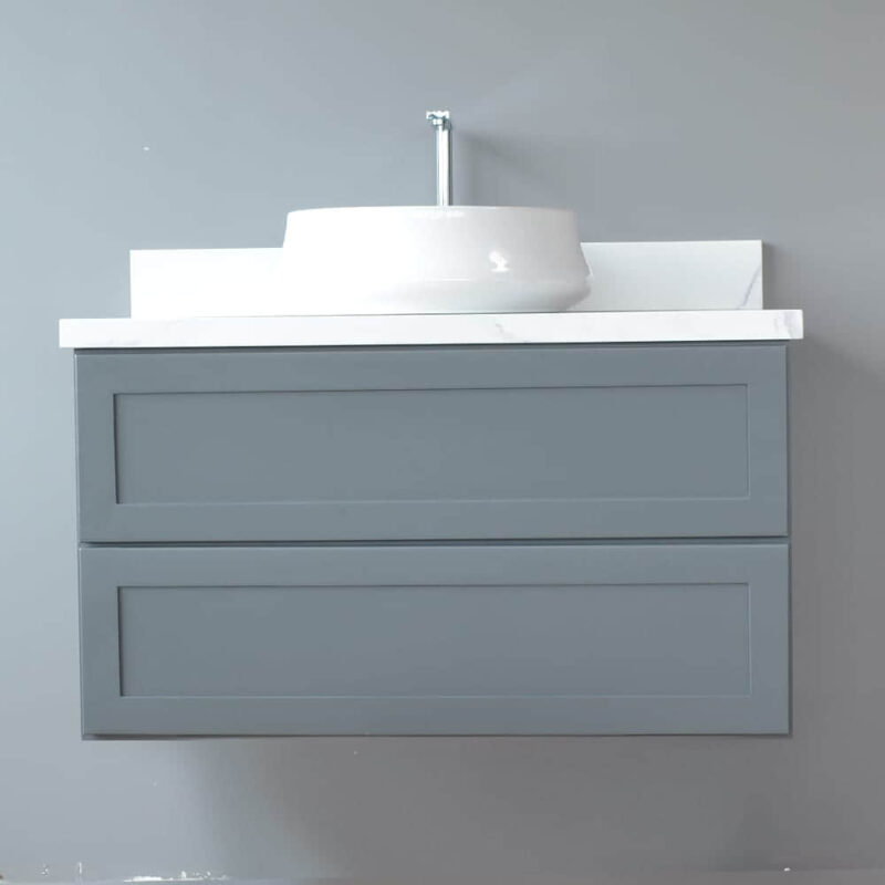 Gray wall-mounted vanity with white sink against a light gray wall.