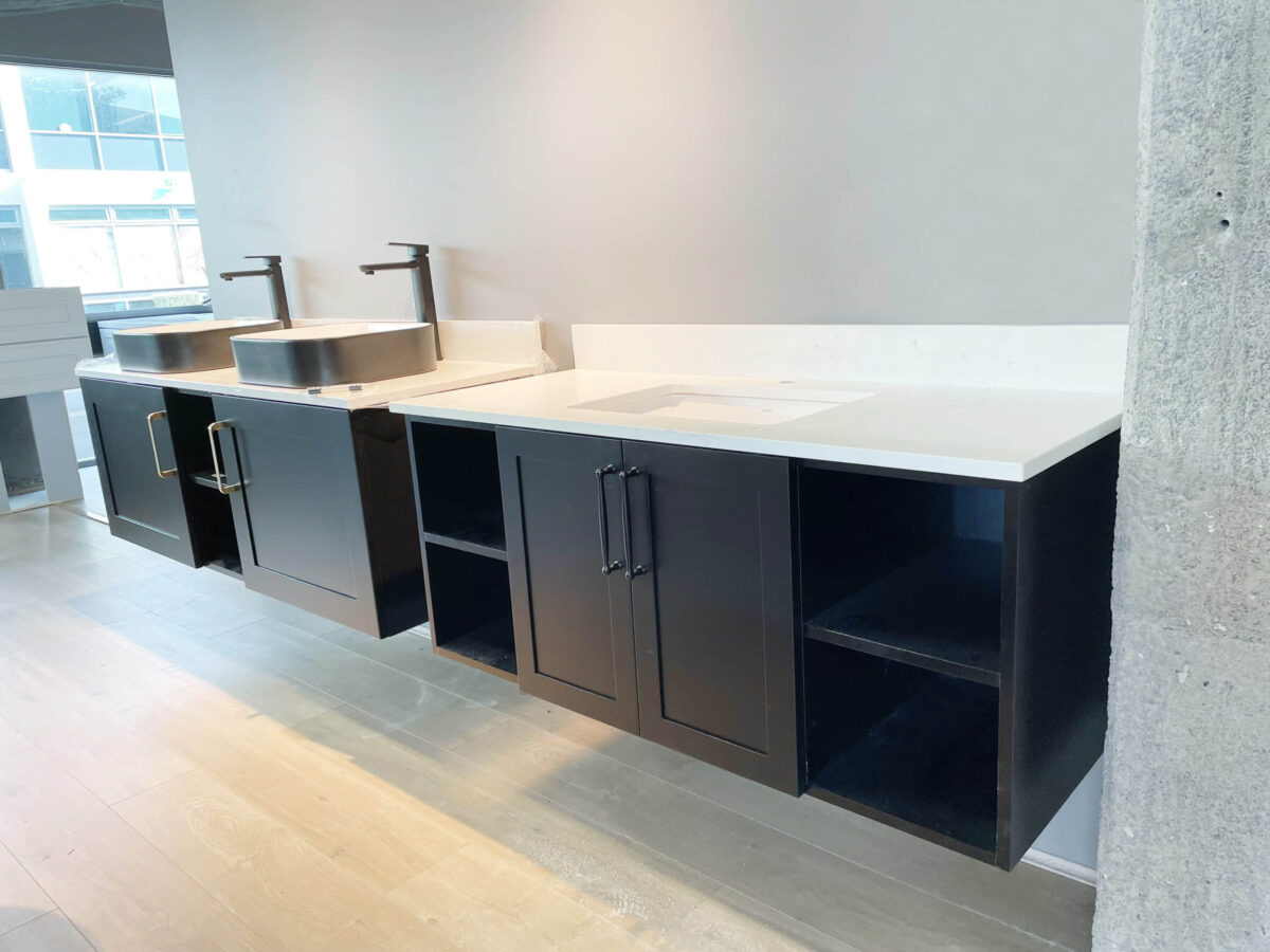 Modern kitchen with black cabinets and dual sinks.
