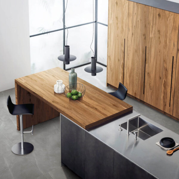 Modern kitchen with wooden table, black stools, and sleek countertops.
