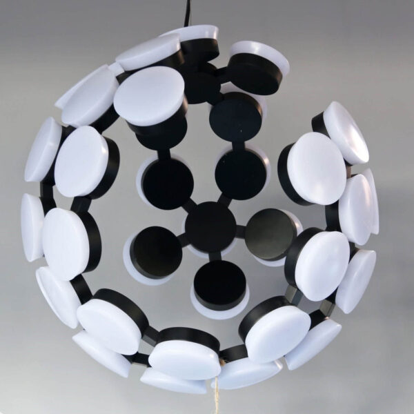 Modern spherical chandelier with black and white circular elements.