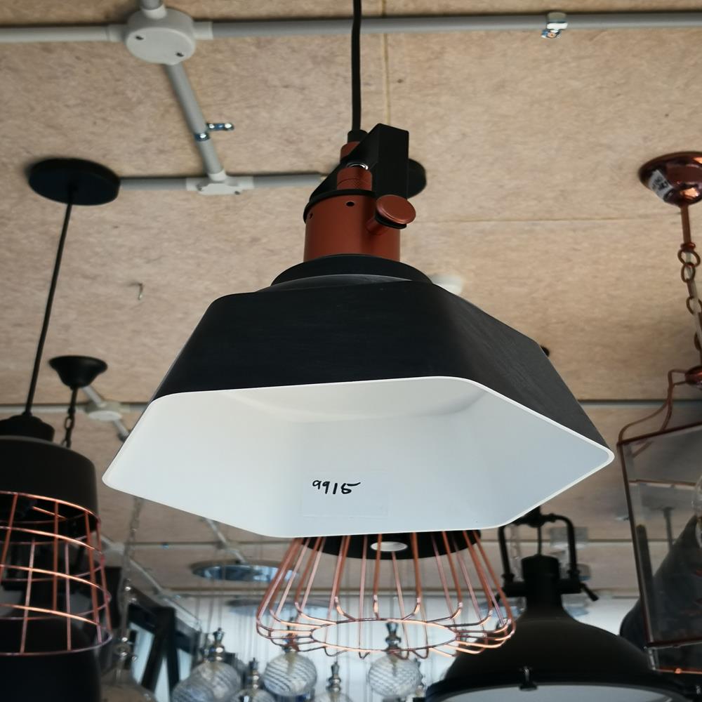 Modern pendant light fixture with black and white design in a showroom.