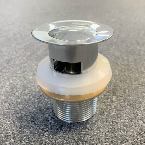 Chrome solid brass pop-up waste with overflow on gray surface.