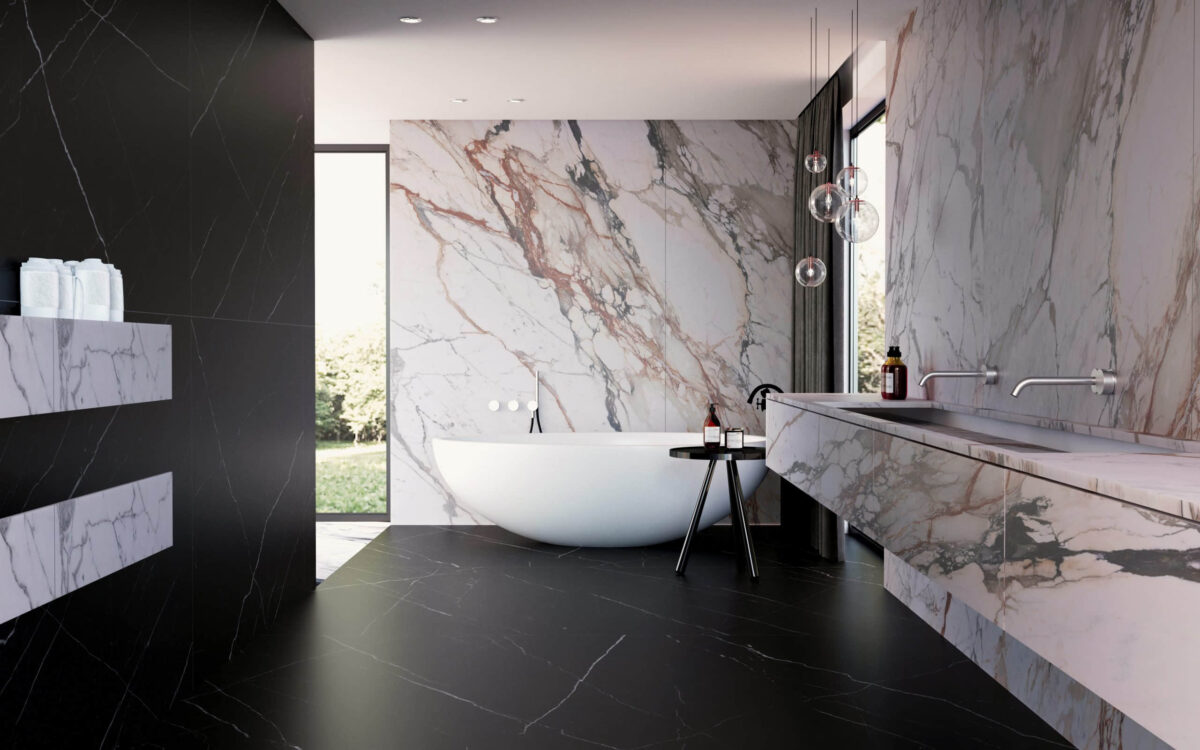 Modern bathroom with marble walls and freestanding bathtub.