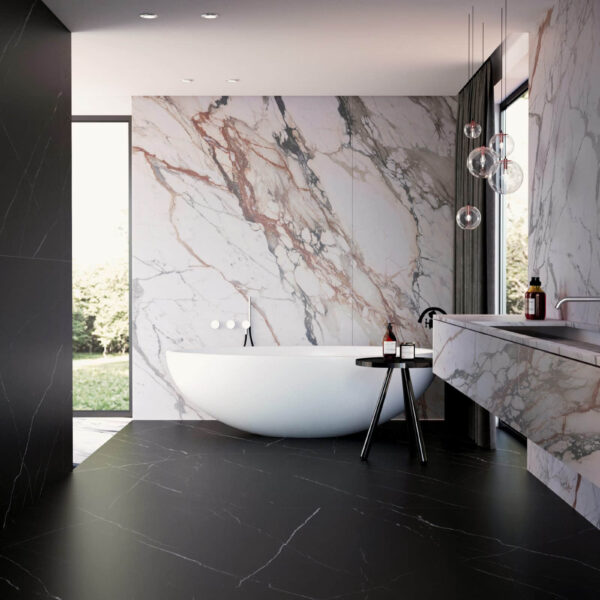 Modern bathroom with marble walls and freestanding bathtub.