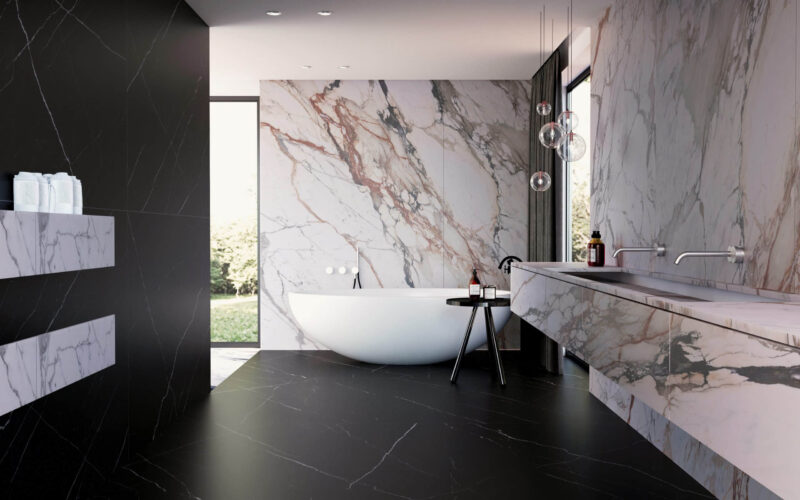 Modern bathroom with marble walls and freestanding bathtub.