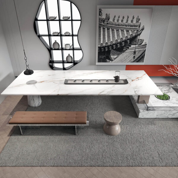 Modern kitchen with white marble island and decorative wall art.