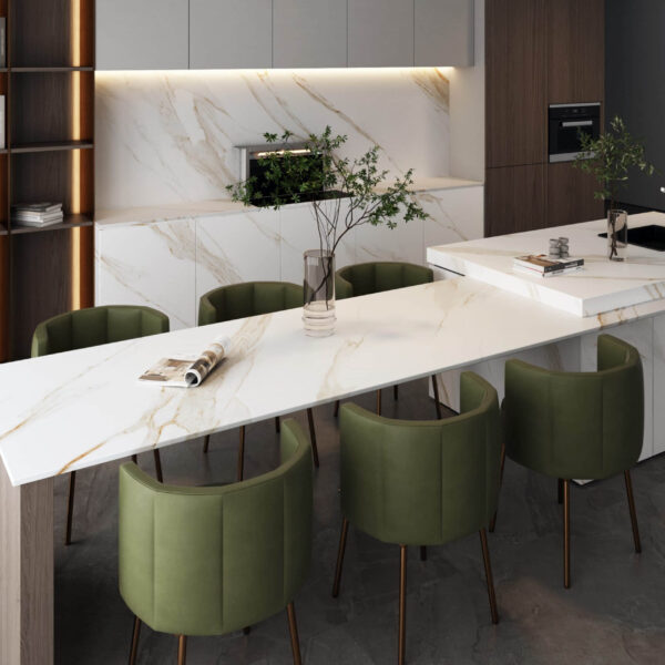 Modern kitchen with marble countertops and green chairs.