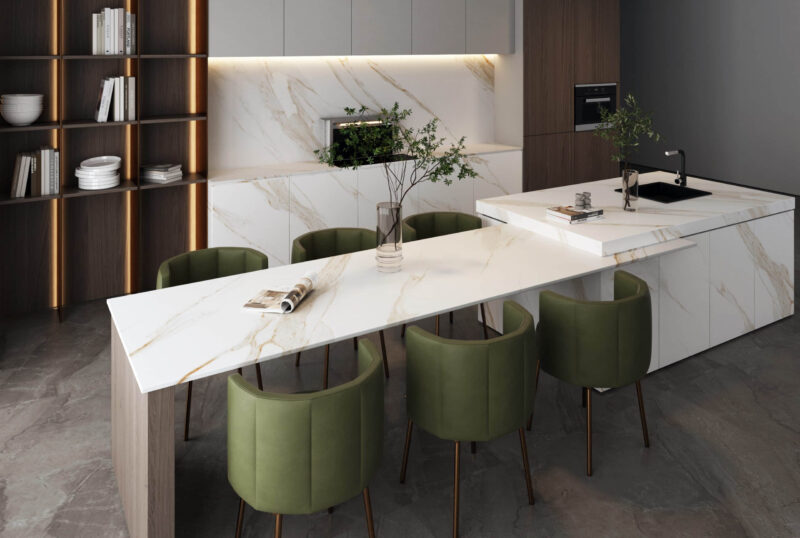 Modern kitchen with marble countertops and green chairs.