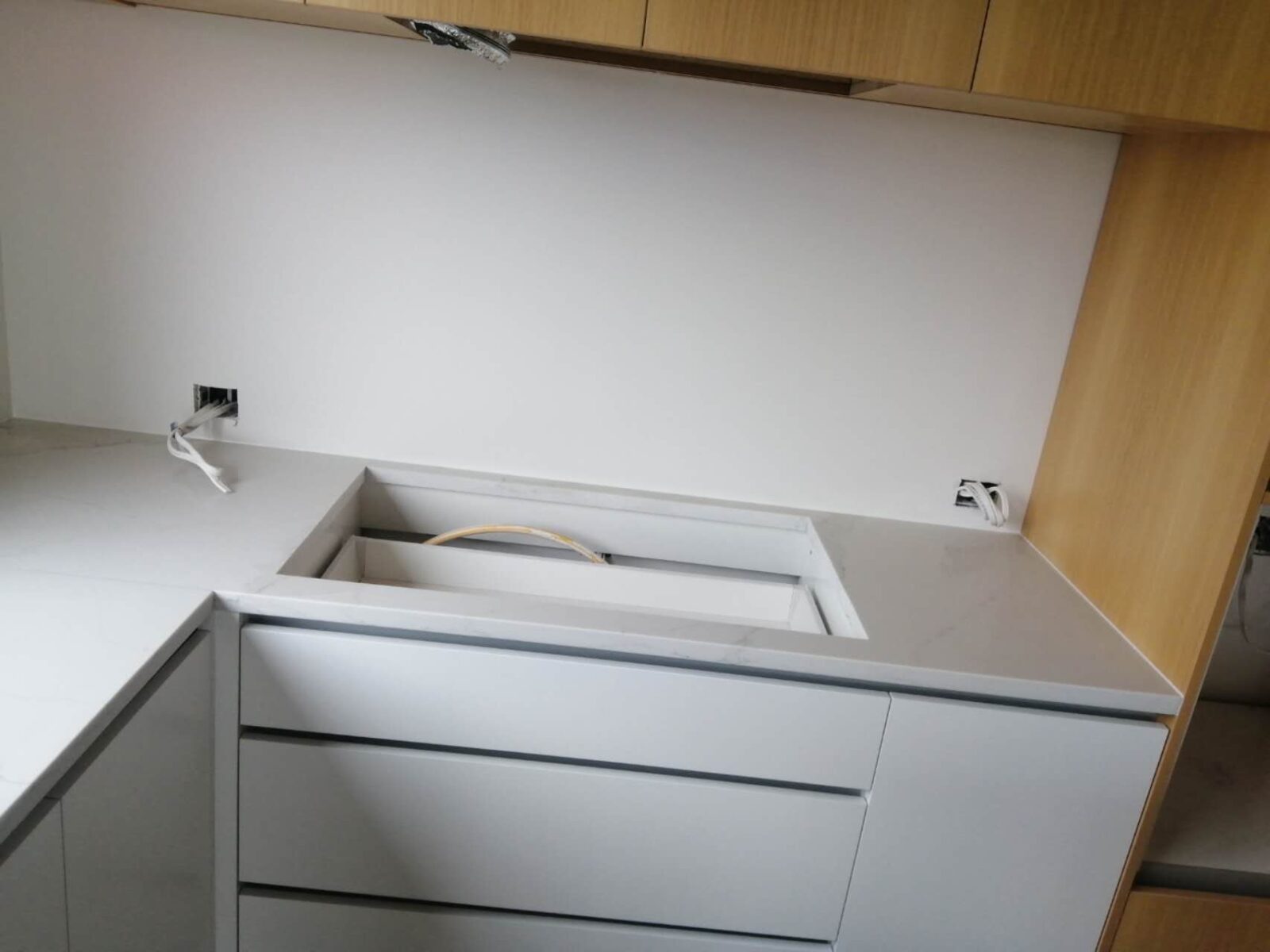 Modern kitchen with Calacatta Belleza countertops and wooden cabinets.