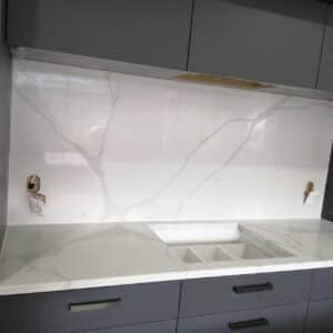 Calacatta Sky Quartz countertop and backsplash in modern kitchen setting.