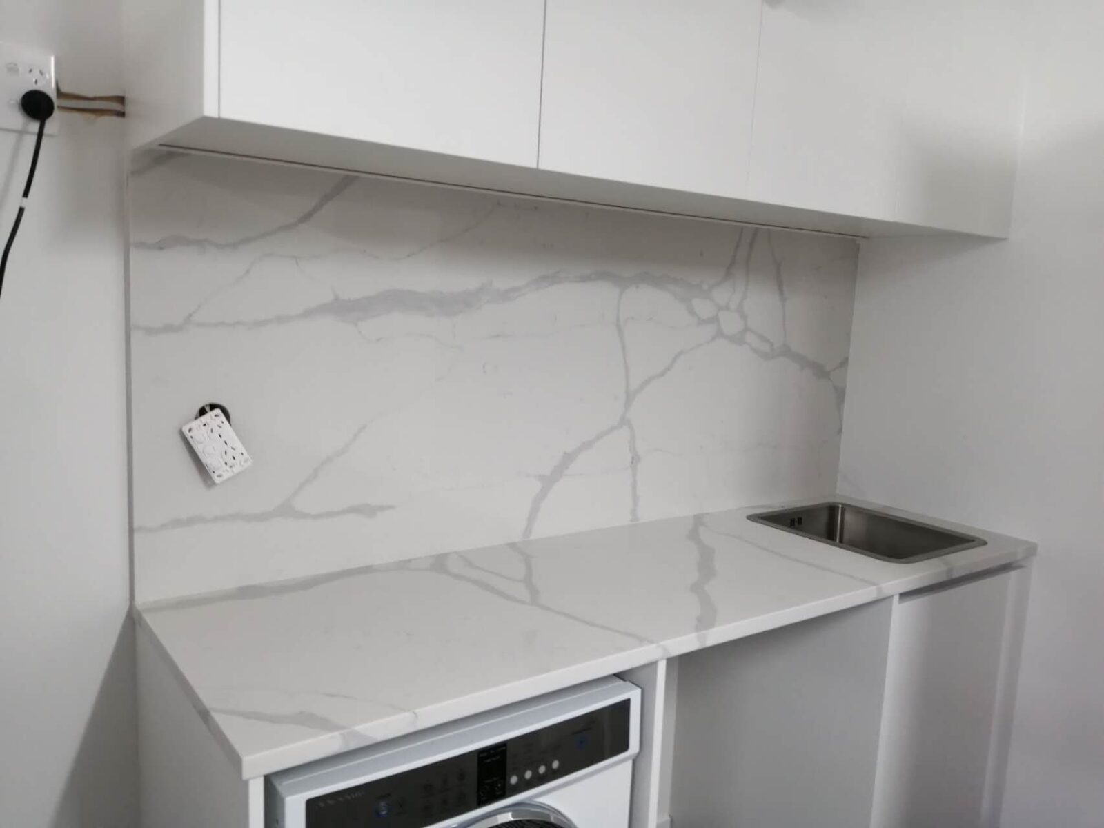 Modern kitchen with Calacatta Sky Quartz countertop and backsplash.