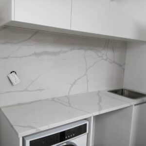 Modern kitchen with Calacatta Sky Quartz countertop and backsplash.