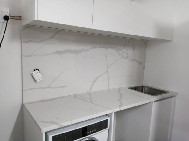 Modern kitchen with Calacatta Sky Quartz countertop and backsplash.