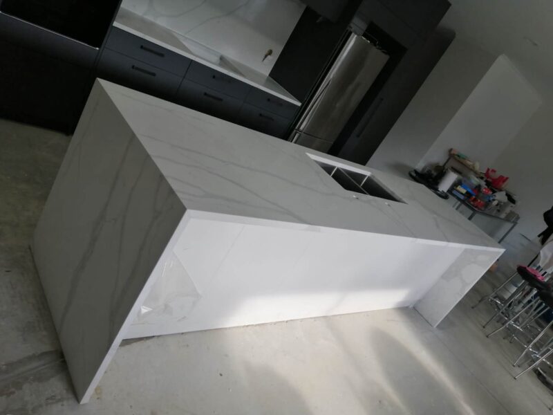 Calacatta Sky Quartz kitchen island in modern kitchen setting.