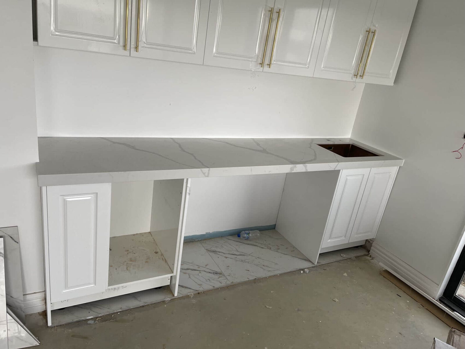 White kitchen cabinets with Calacatta Sky Quartz countertop.