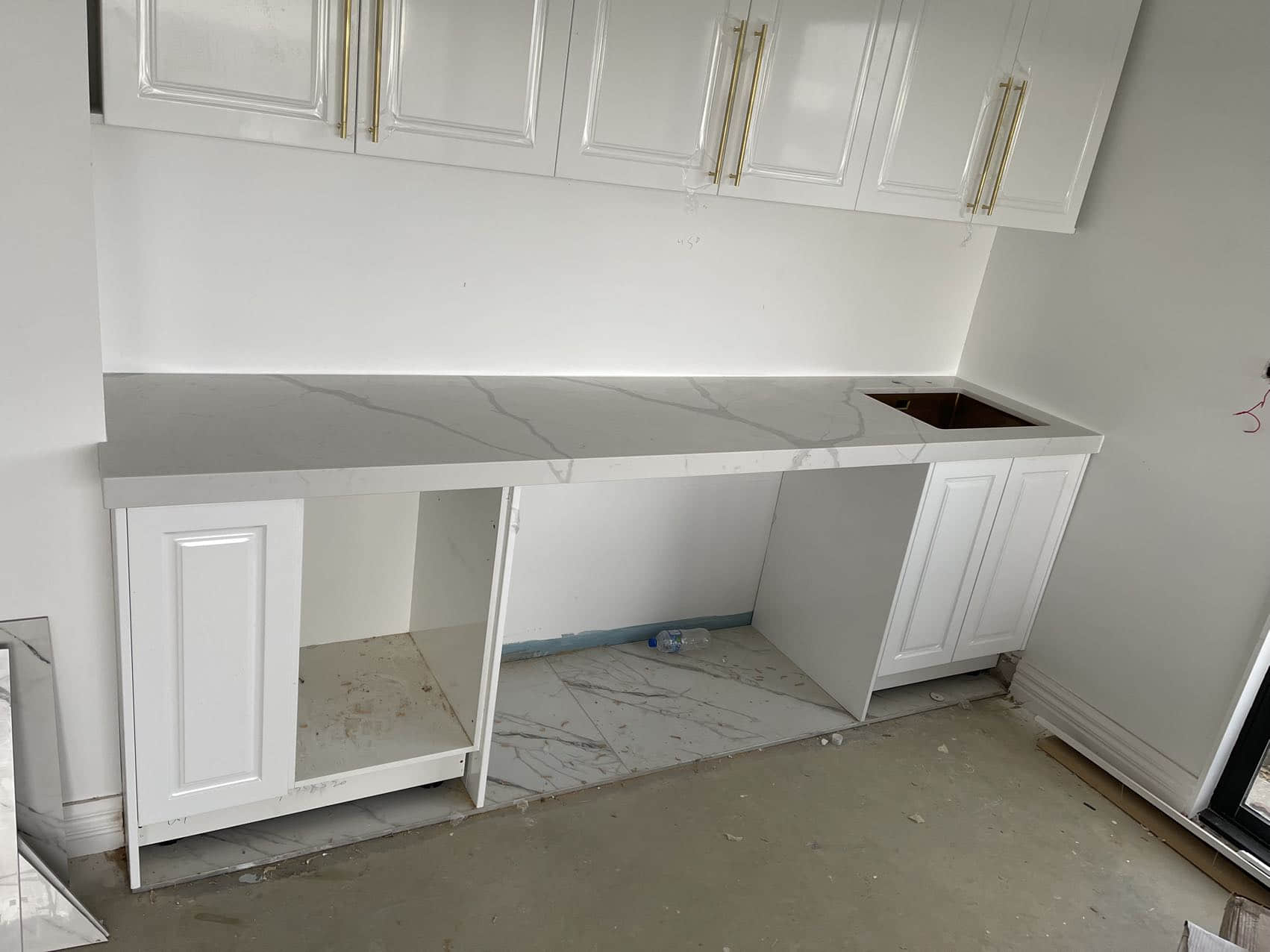 White kitchen cabinets with Calacatta Sky Quartz countertop.