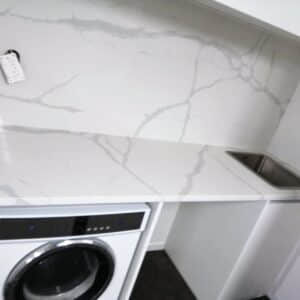 Laundry room with Calacatta Sky Quartz countertop and backsplash.
