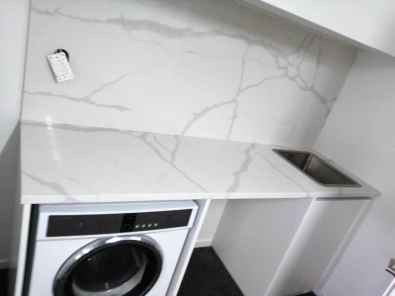 Laundry room with Calacatta Sky Quartz countertop and backsplash.
