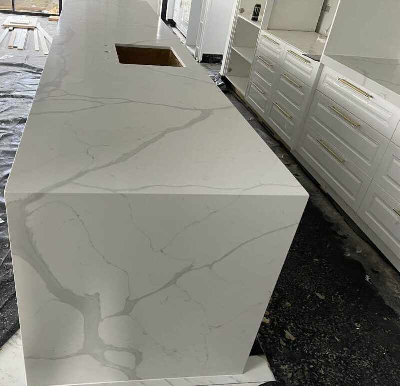 Calacatta Sky Quartz countertop in modern kitchen setting.