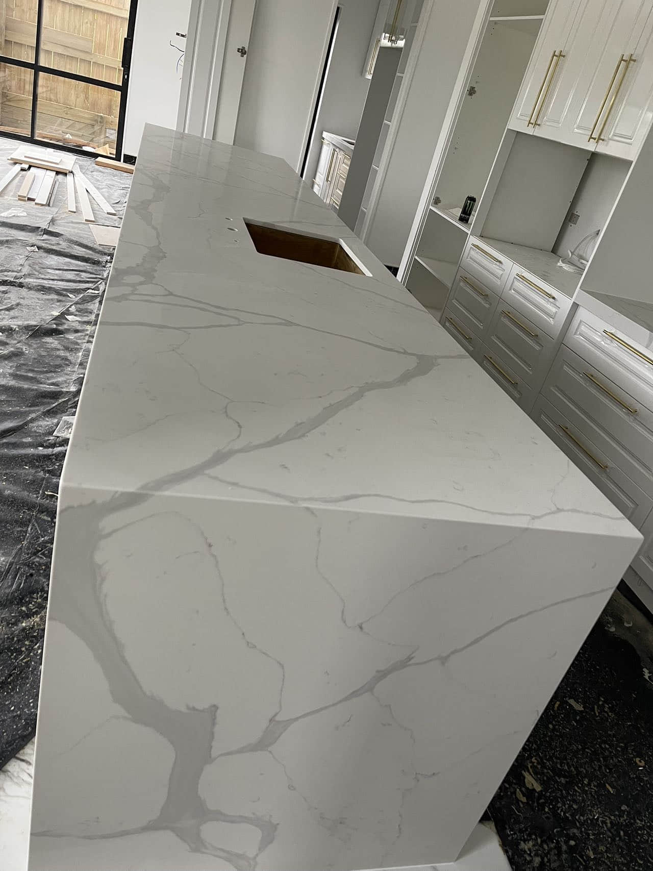 Calacatta Sky Quartz kitchen countertop installation in progress.