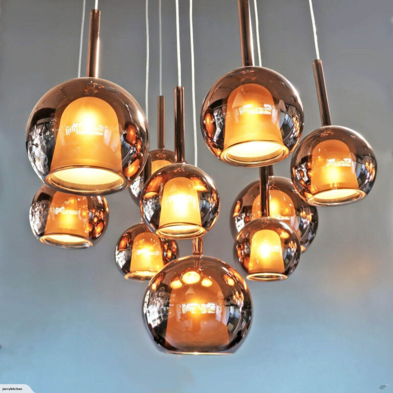 Modern copper pendant lights hanging from ceiling.