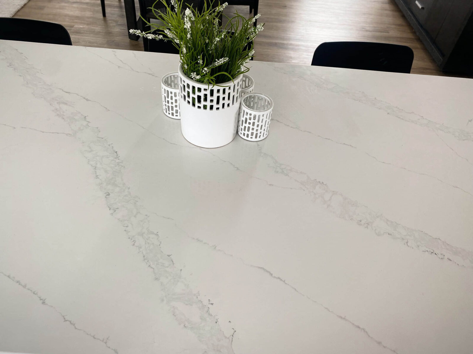Marble countertop with plant and candle holders.
