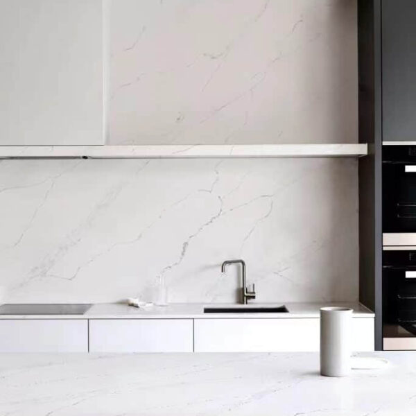 Modern kitchen with marble countertops and minimalist design.