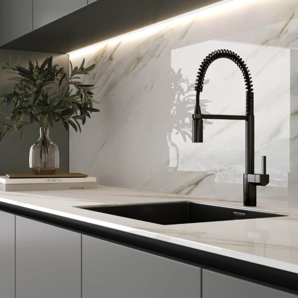 Modern kitchen with marble backsplash and sleek black faucet.