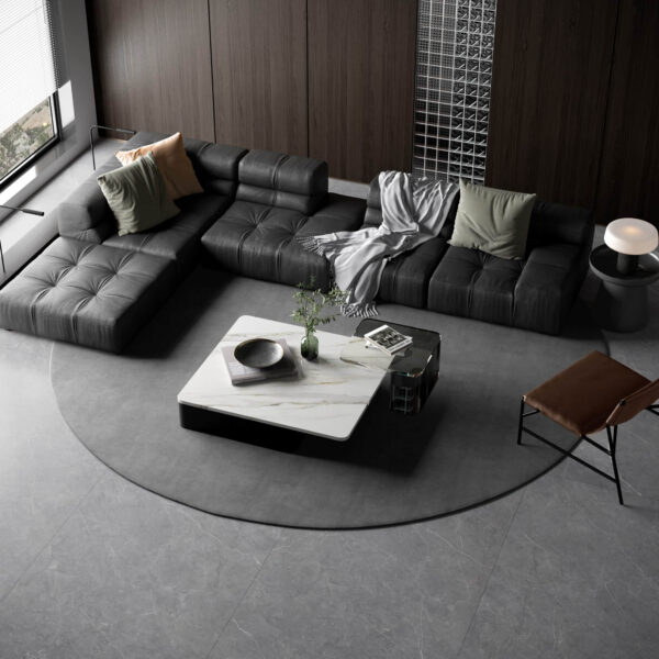 Modern living room with dark sectional sofa and marble coffee table.