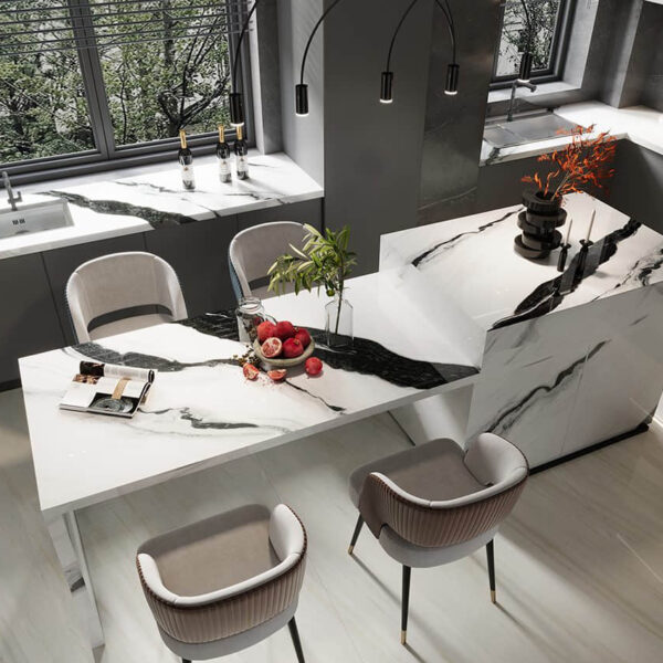 Modern kitchen with marble countertops and stylish bar stools.