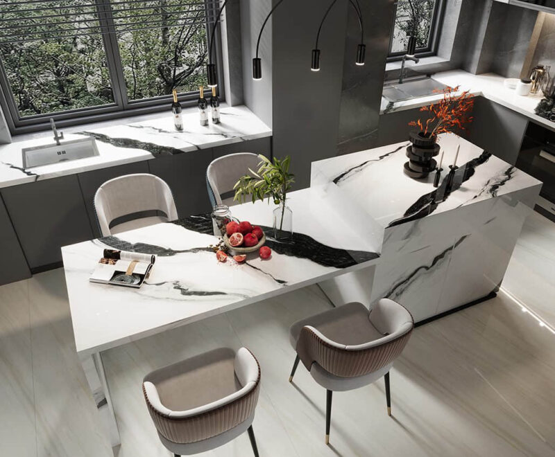 Modern kitchen with marble countertops and stylish bar stools.