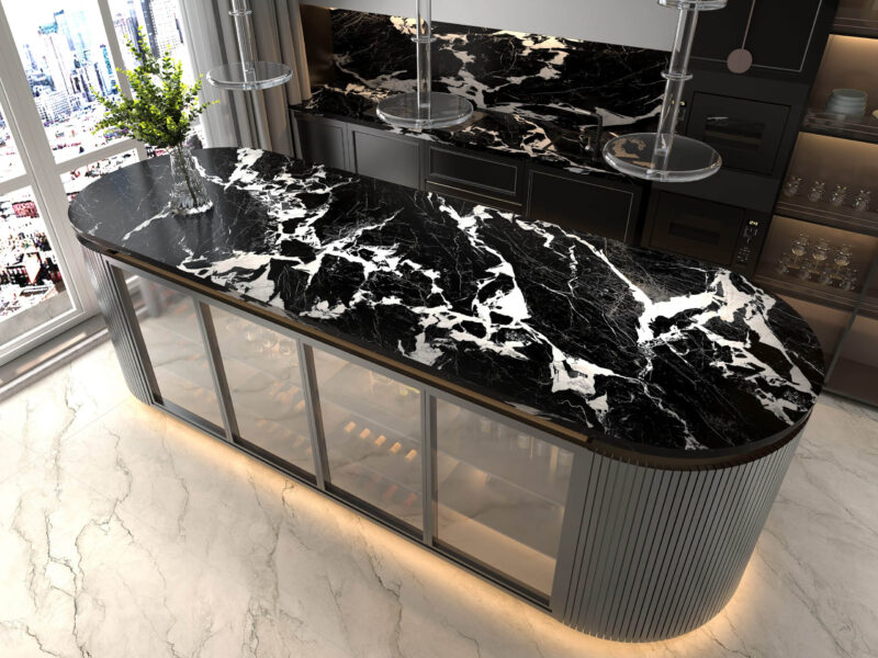 Black marble kitchen countertop with white veining, modern design.
