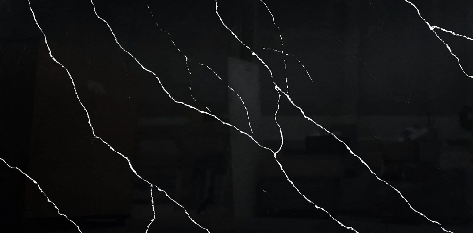 Black marble countertop with white veining pattern.