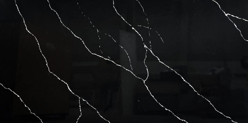 Black marble countertop with white veining pattern.