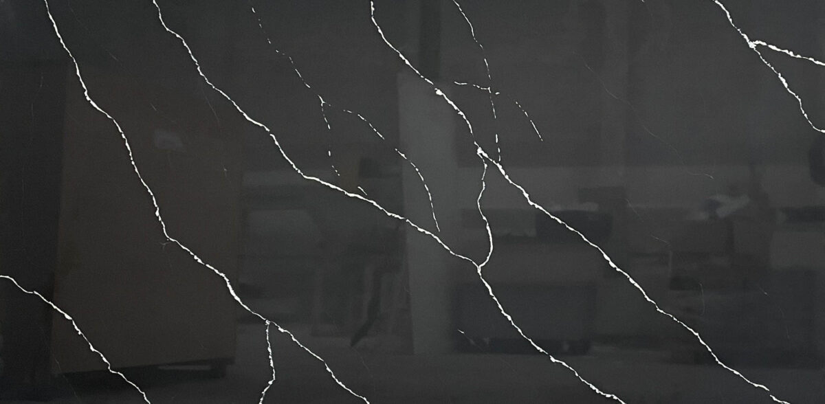 Dark marble countertop with white veining pattern.