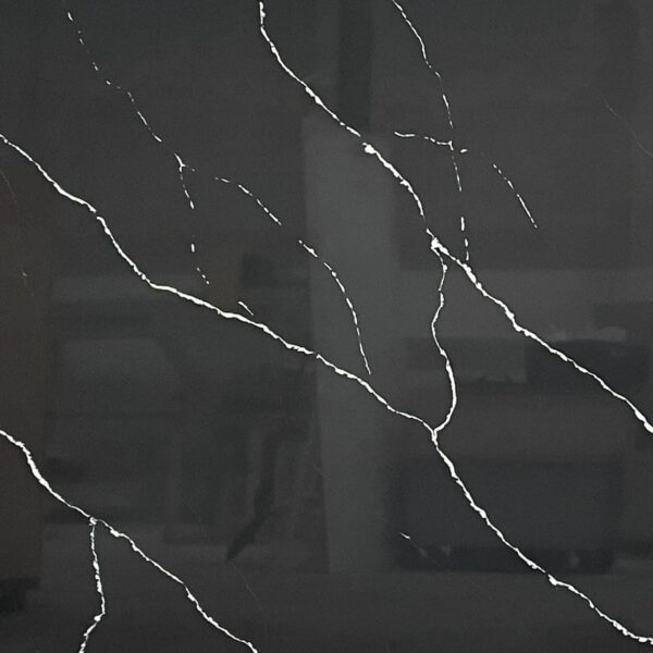 Dark marble countertop with white veining pattern.