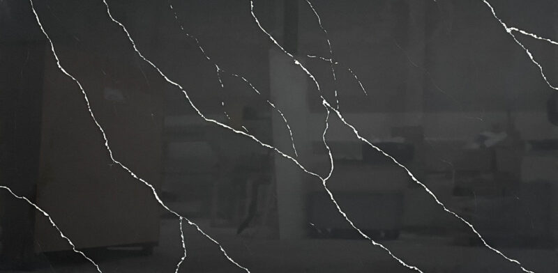 Dark marble countertop with white veining pattern.