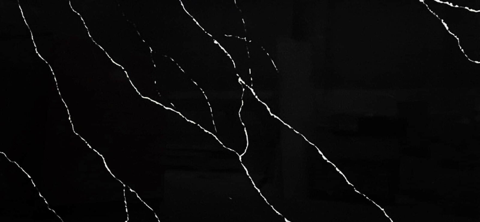 Black marble countertop with white veining pattern.