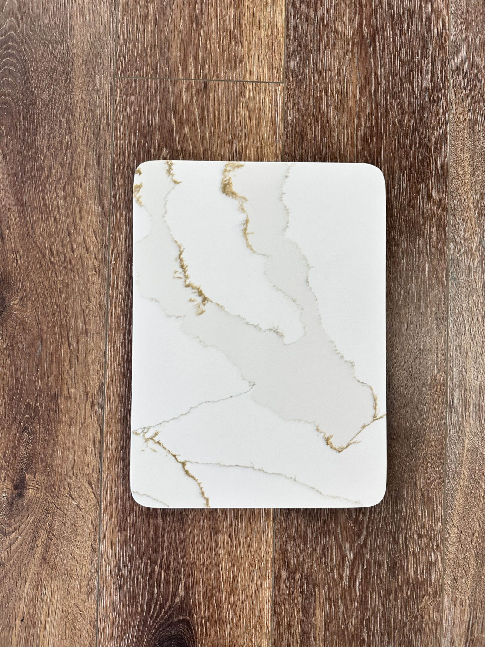 Marble-patterned rectangular plate on wooden surface.