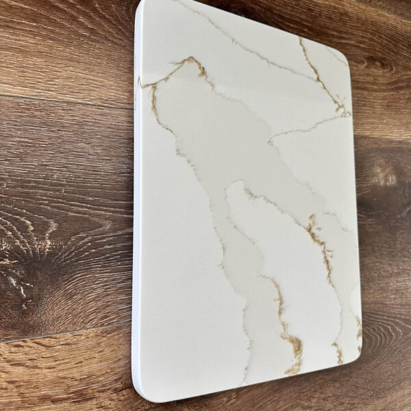 Marble cutting board on wooden kitchen counter.