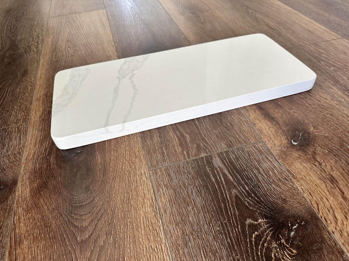 Marble countertop sample on wooden floor.