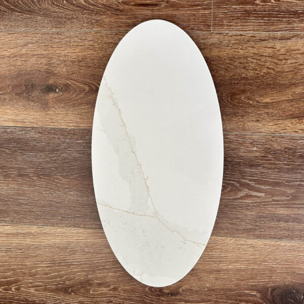 Oval marble plate on wooden table background.