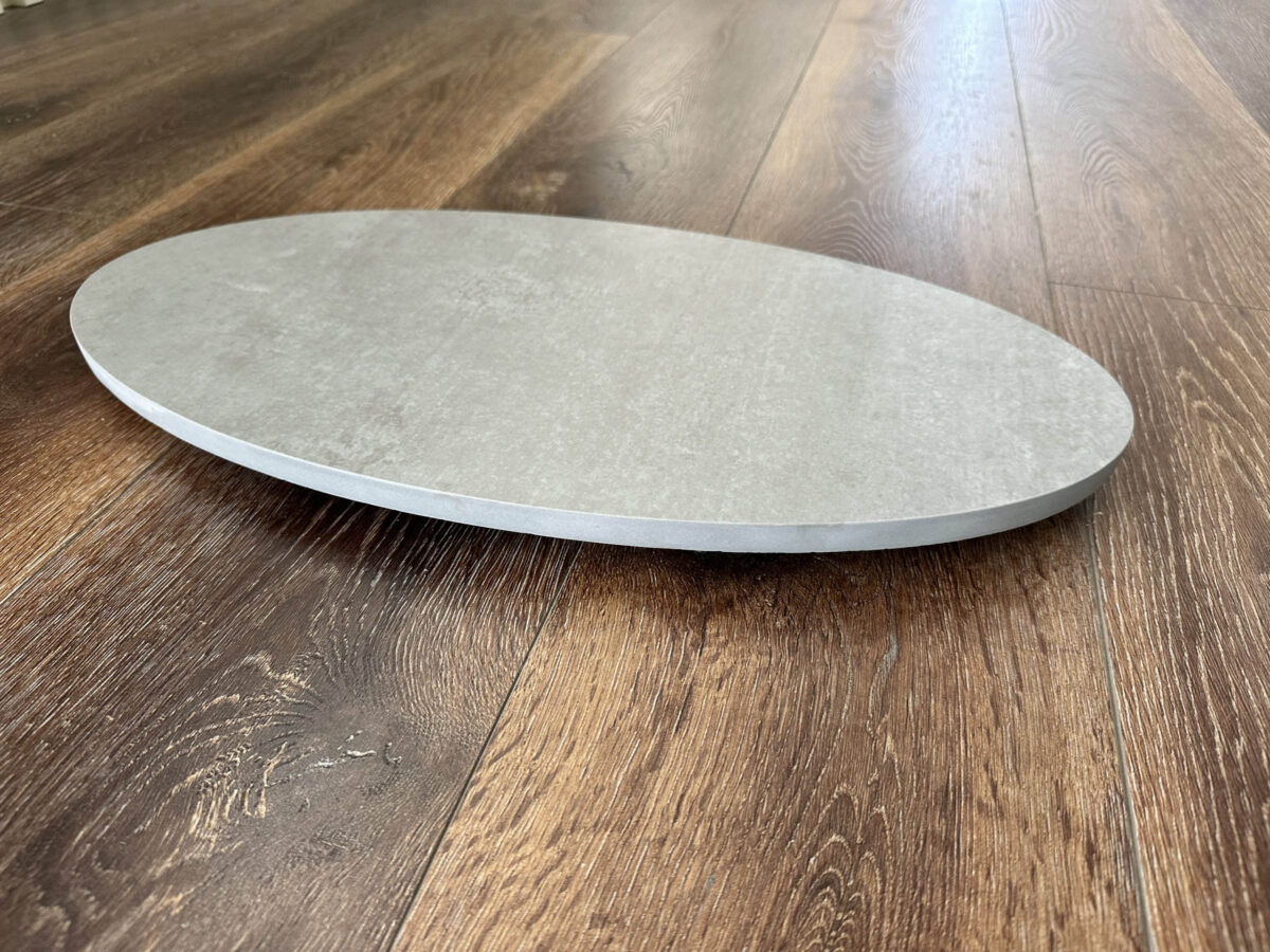 Round stone plate on wooden floor.